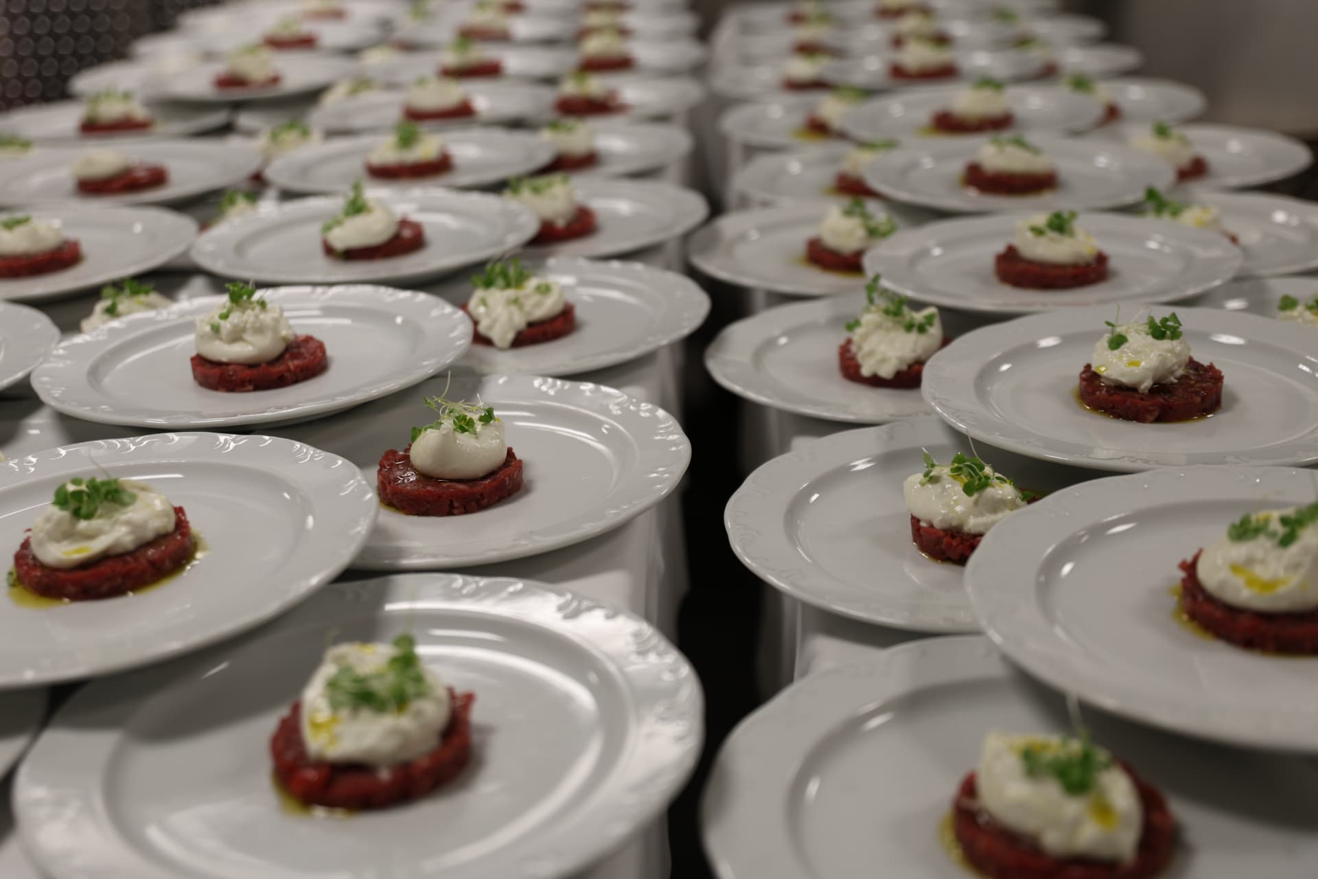 Plated carpaccio with burrata at a corporate gala dinner
