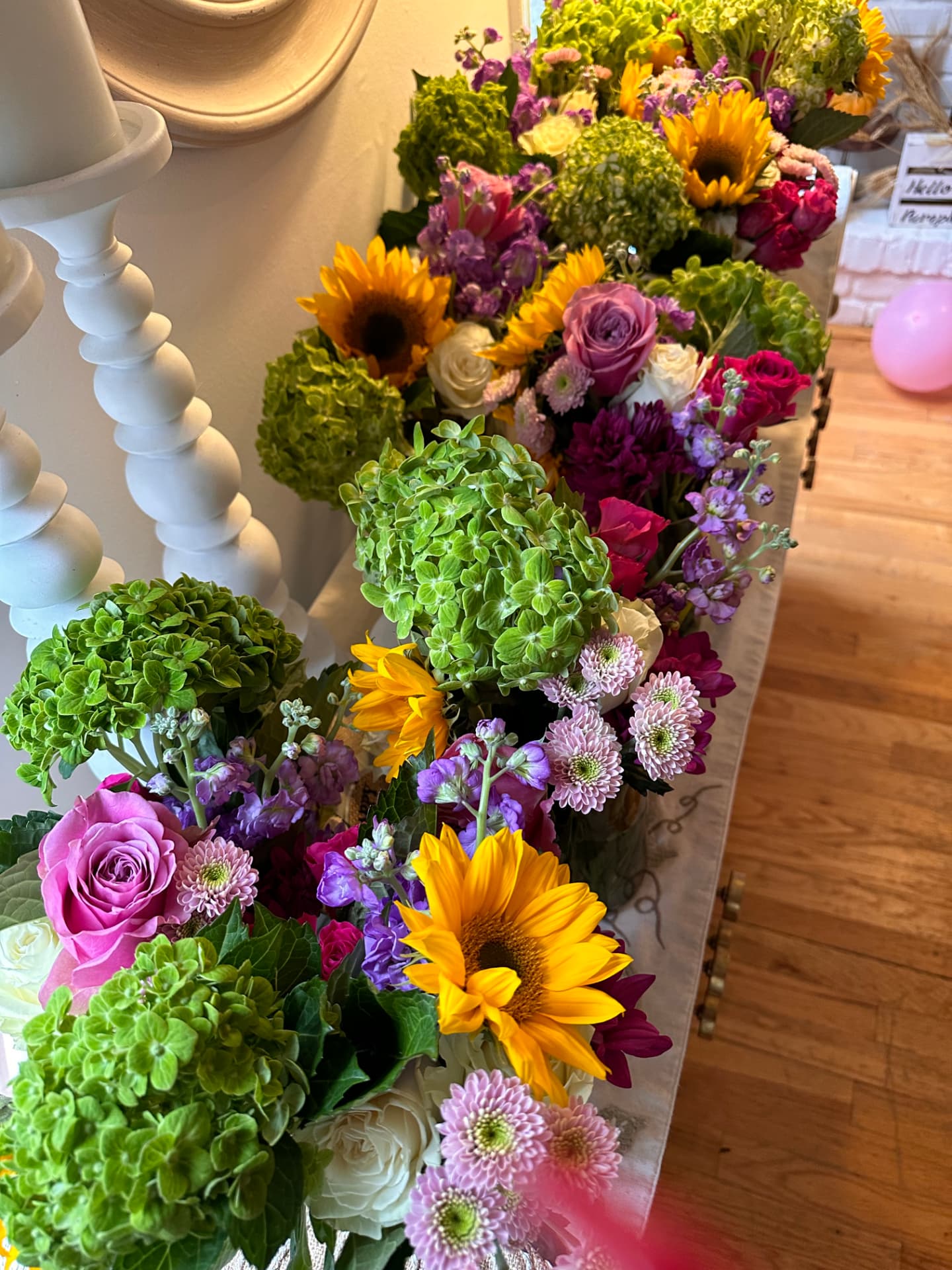 Vibrant flower bar arrangement with sunflowers, roses and hydrangeas
