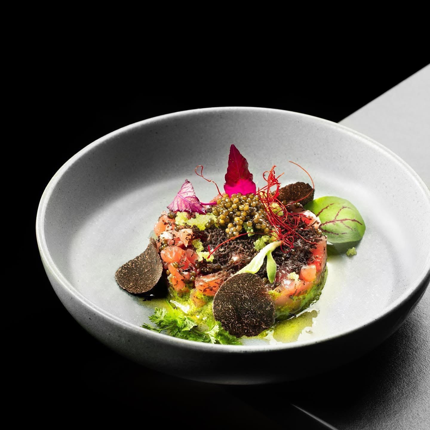 Elegant plated Italian dinner with truffle, caviar, and fresh herbs