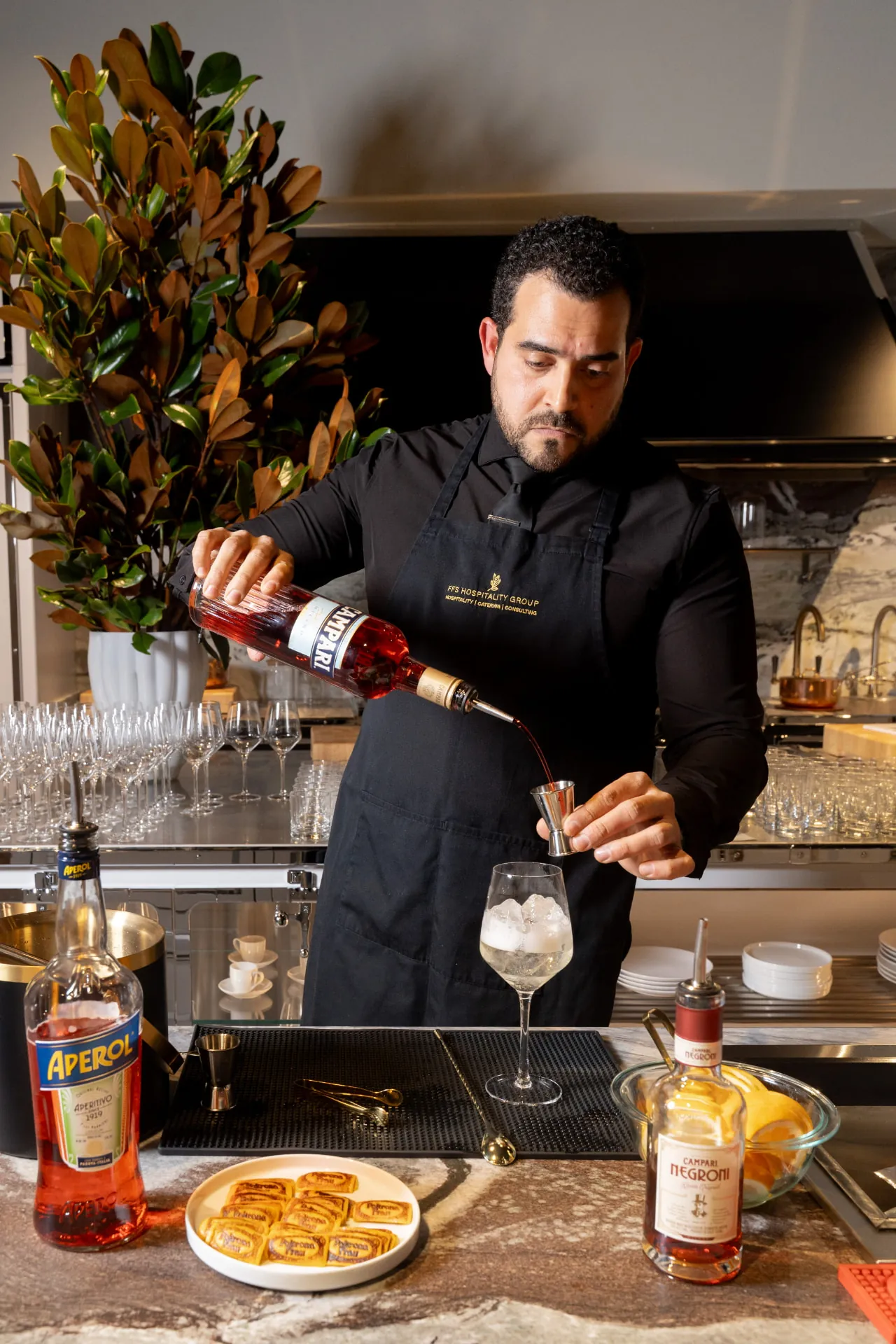 Bartender pouring Campari for an Italian cocktail experience