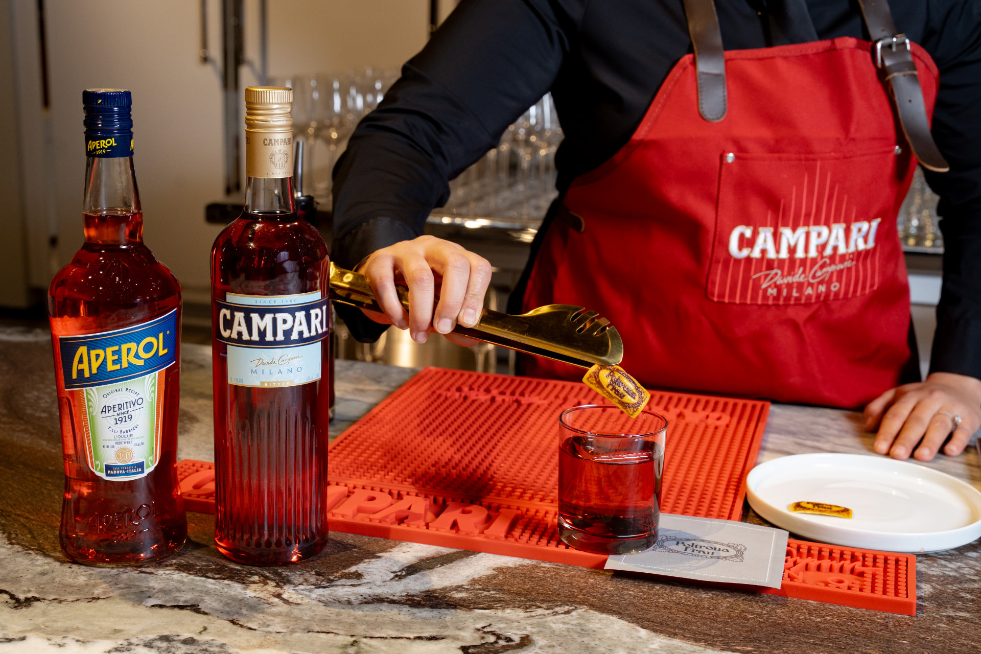 Aperol and Campari cocktail service with a branded garnish