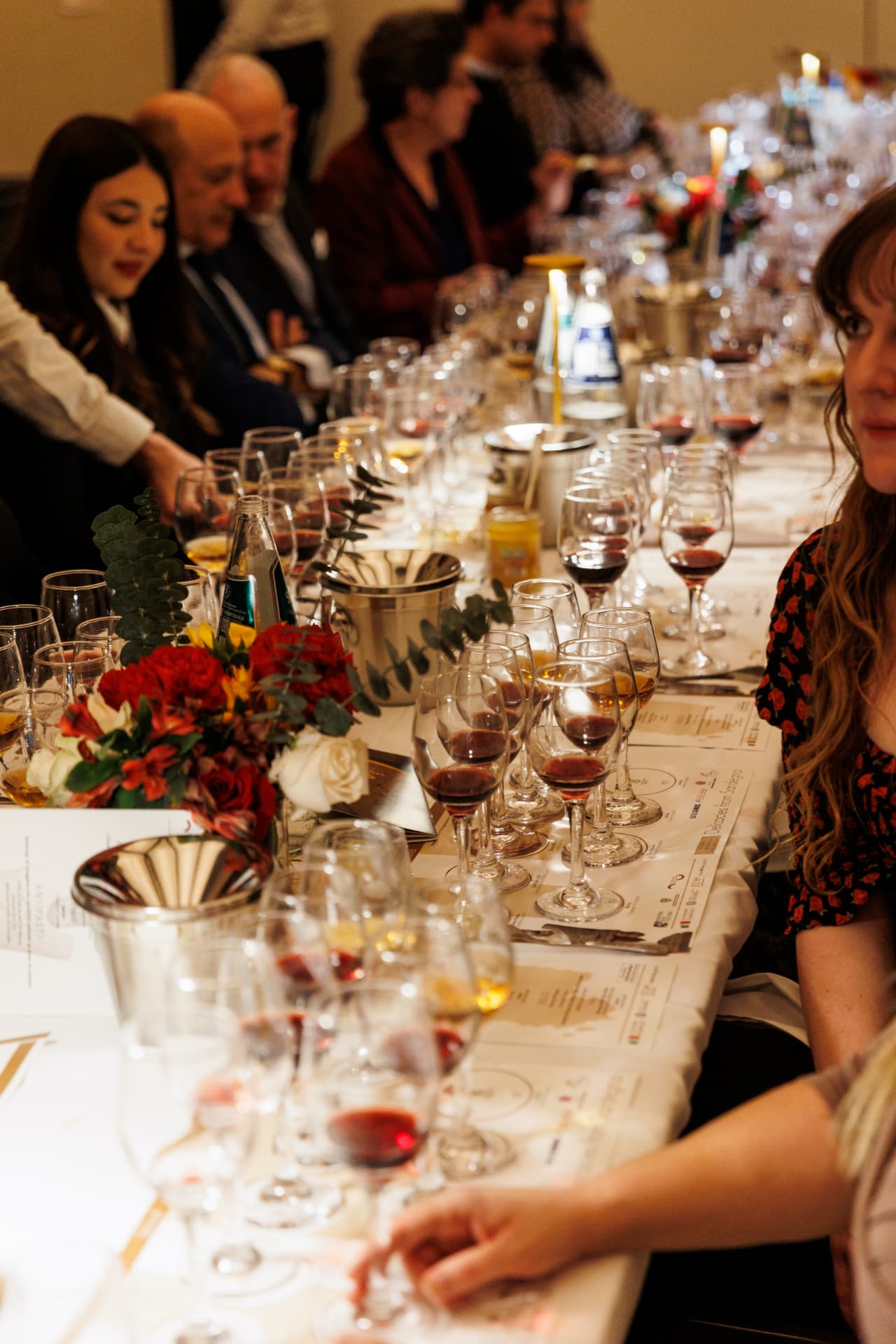 Corporate guests seated at an elegant long-table wine dinner