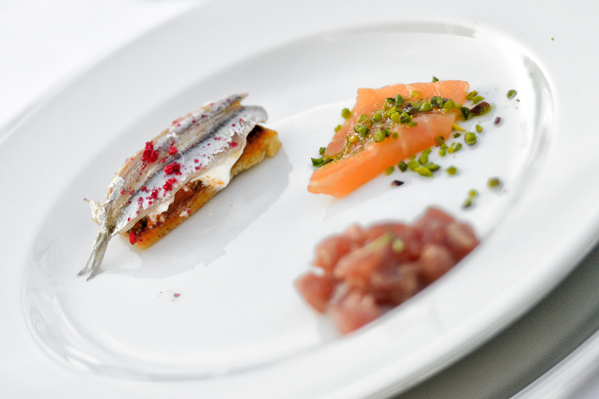 Elegant trio of plated Italian seafood preparations