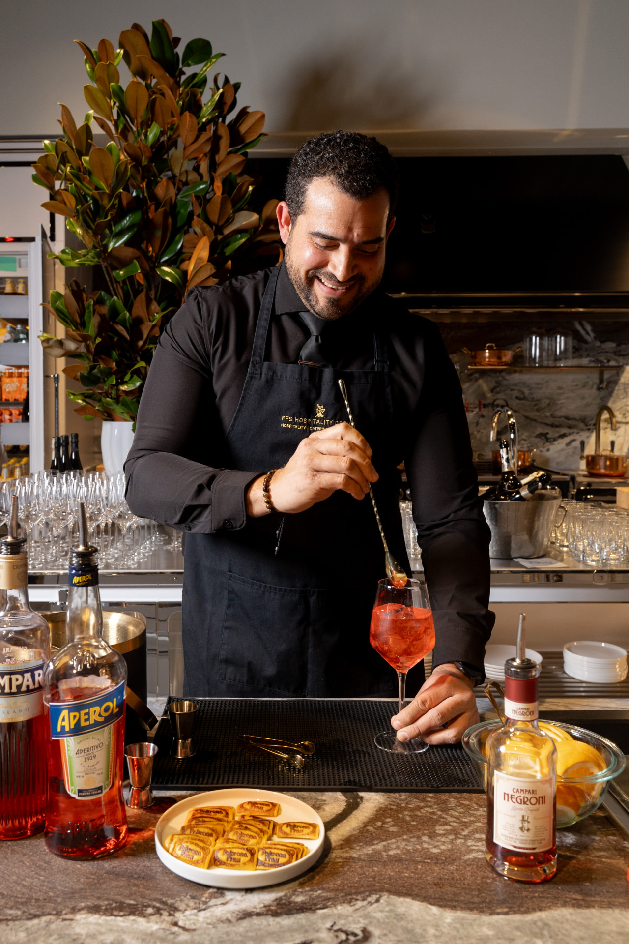 Bartender preparing an Italian Aperol spritz cocktail