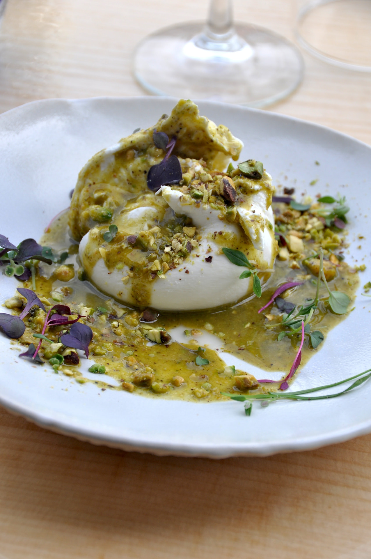 Burrata with pistachio pesto, microgreens and edible flowers